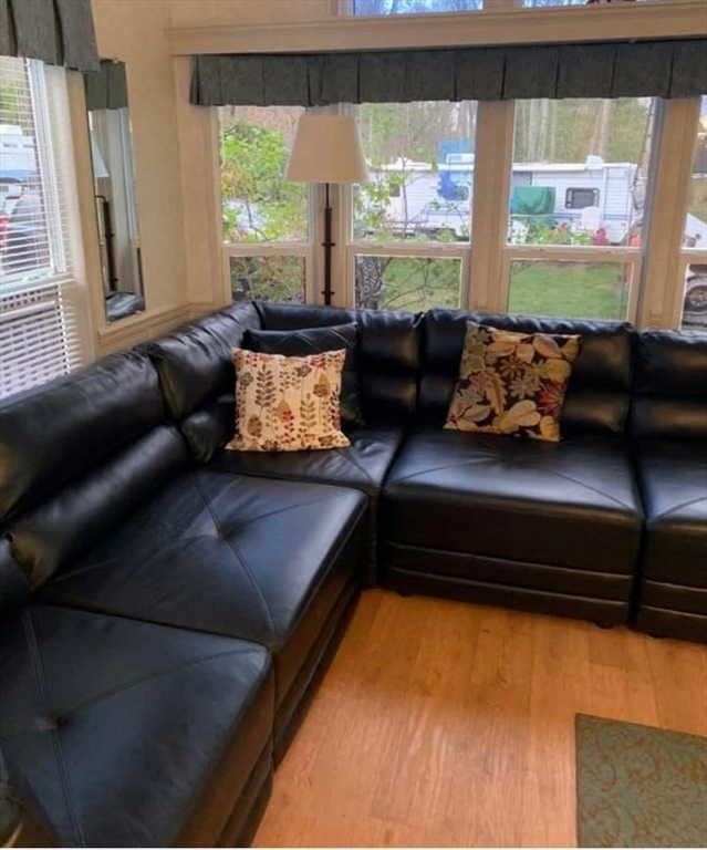 262 Shetucket Turnpike, Unit 112 Griswold, CT 06351 - Photo 8 of 25 a living room with furniture and a large window