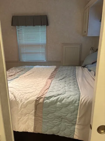 a bed sitting in a bedroom next to a window