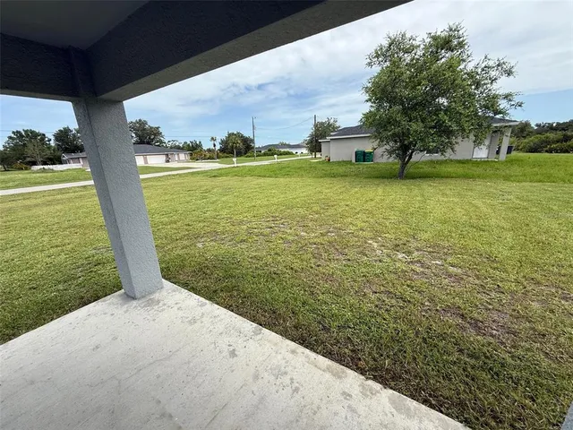 a view of a field with an ocean view