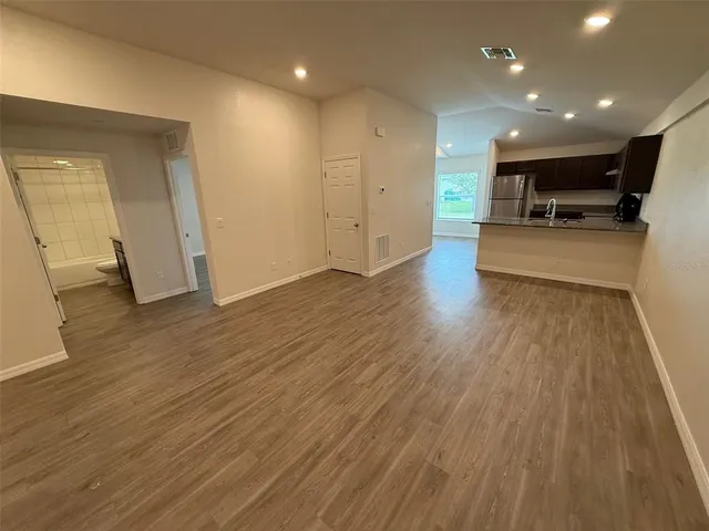 a view of kitchen with cabinets and wooden floor