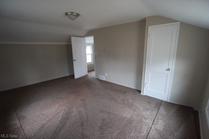 3606 Shelby Road Youngstown, OH 44511 - Photo 14 of 33 Bonus room featuring vaulted ceiling and dark colored carpet