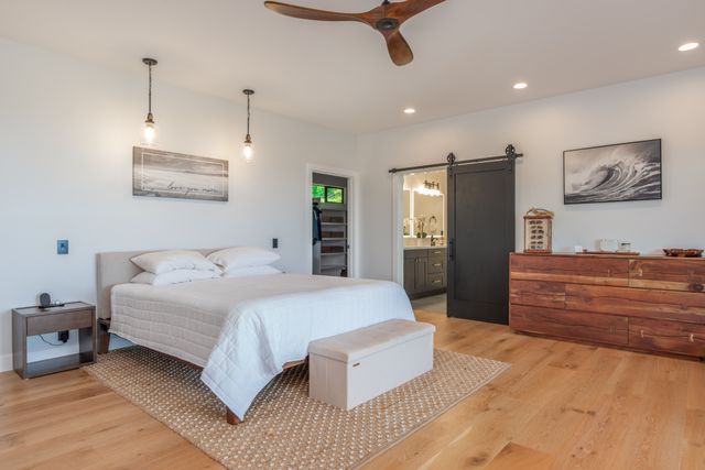 a bedroom with a large bed and a large window
