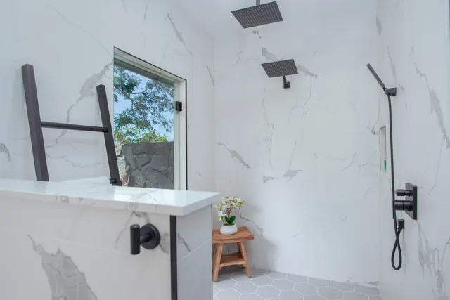 a bathroom with a toilet and a shower
