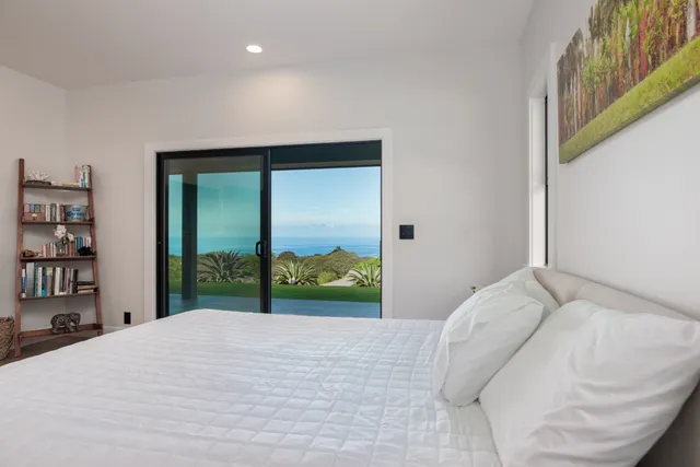 a vase of flowers sitting on a white shelf