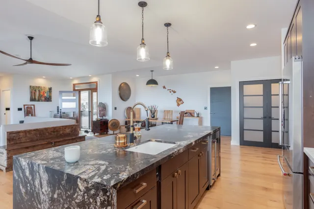 a kitchen with center island a sink stainless steel appliances and cabinets