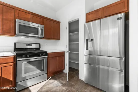 a kitchen with stainless steel appliances granite countertop a sink and a microwave