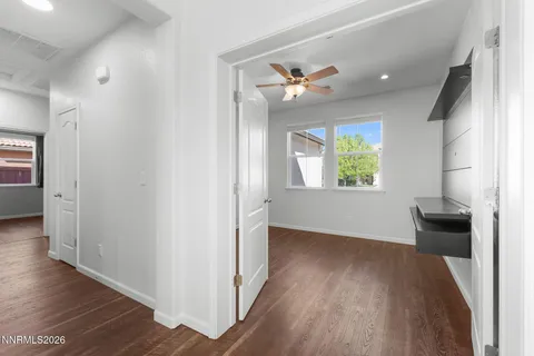 a room with wooden floor chandelier and windows