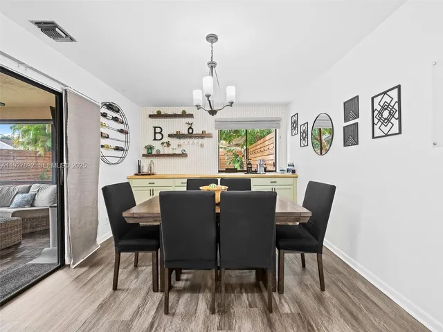 a dining room with furniture a rug and wooden floor
