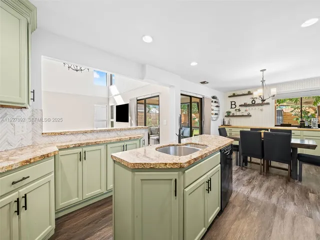 a kitchen with a sink stove and wooden cabinets