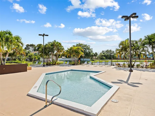 a swimming pool with outdoor seating and yard
