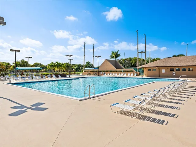 a view of swimming pool with outdoor seating and city view