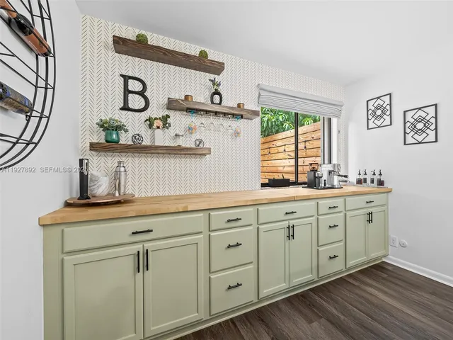 a view of cabinets a sink and a window