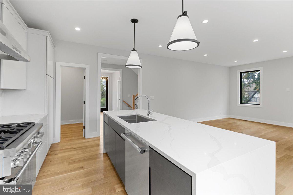 71 Maple Street Princeton, NJ 08542 - Photo 23 of 68 a kitchen with stainless steel appliances granite countertop a sink a stove and a wooden floors