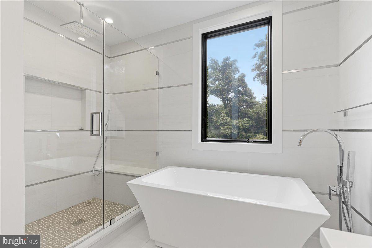 71 Maple Street Princeton, NJ 08542 - Photo 37 of 68 a white bath tub sitting next to a shower