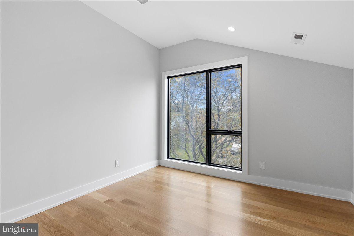 71 Maple Street Princeton, NJ 08542 - Photo 38 of 68 an empty room with wooden floor and windows