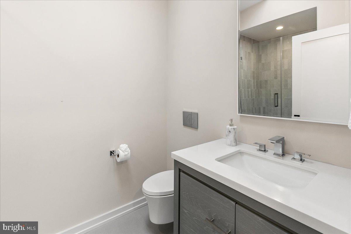 71 Maple Street Princeton, NJ 08542 - Photo 40 of 68 a bathroom with a sink a toilet and a mirror