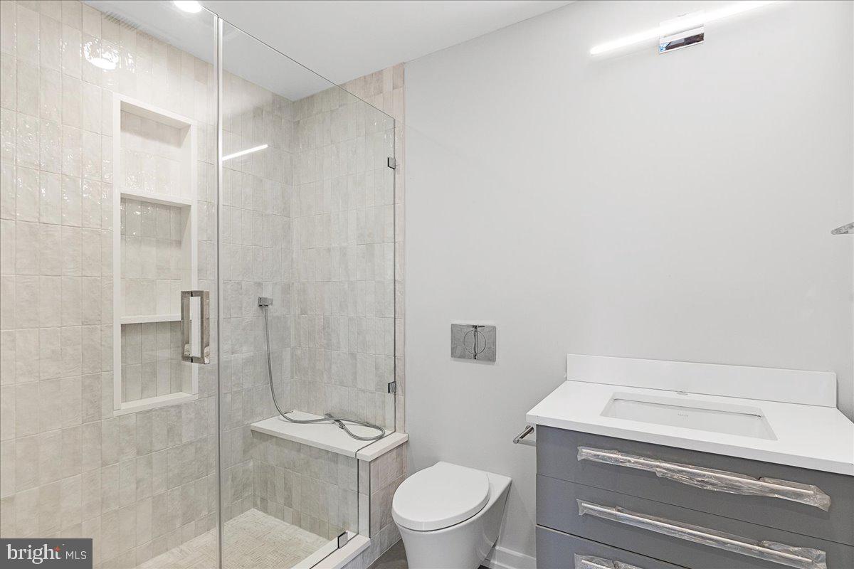 71 Maple Street Princeton, NJ 08542 - Photo 42 of 68 a bathroom with a shower a toilet and a sink