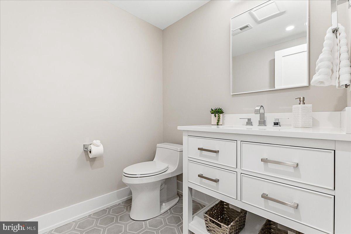 71 Maple Street Princeton, NJ 08542 - Photo 51 of 68 a bathroom with a toilet sink and mirror