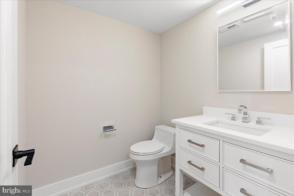 71 Maple Street Princeton, NJ 08542 - Photo 63 of 68 a bathroom with a toilet a sink and mirror