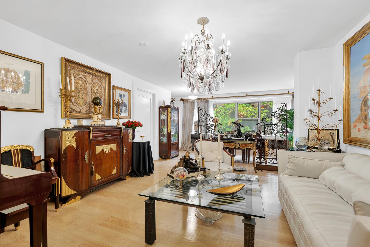 a living room with fireplace furniture and a chandelier