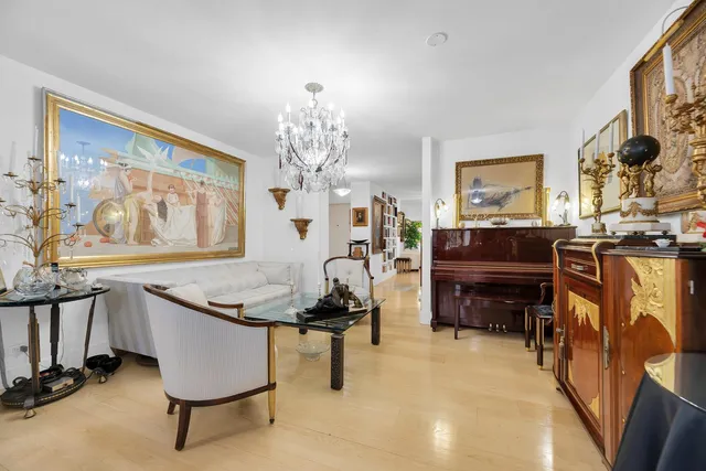 a living room with furniture and a chandelier