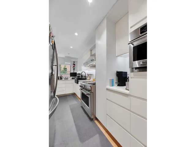 a bathroom with a double vanity sink toilet and shower
