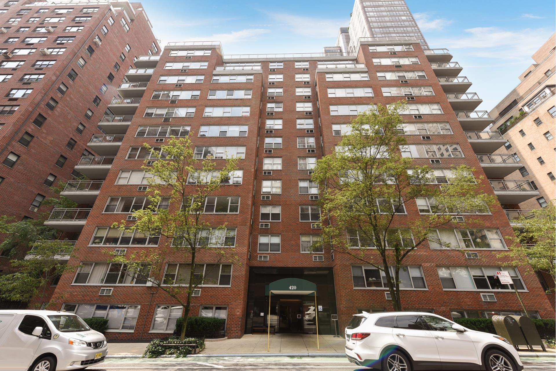 420 East 55th Street, Unit 3FG Manhattan, NY 10022 - Photo 7 of 8 a view of a buildings and cars parked in front of it