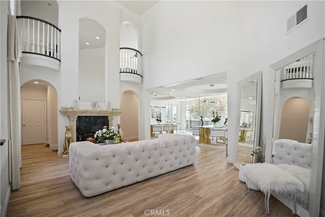 a living room with furniture fireplace and wooden floor