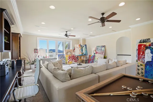 a living room with furniture and a view of kitchen