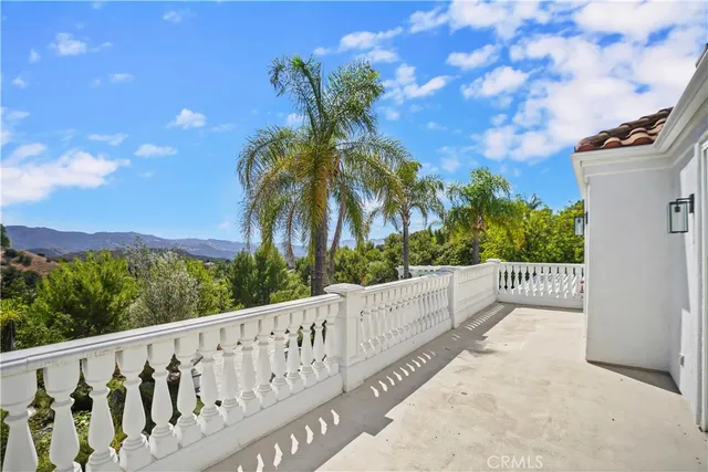 a view of a balcony with wooden fence