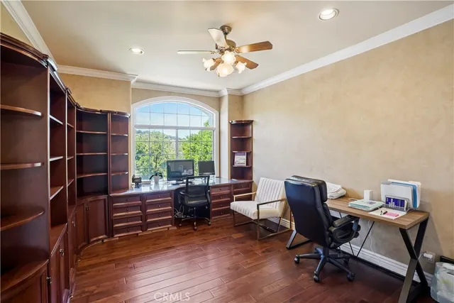 a workspace with wooden floor and a window
