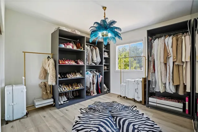 a bedroom with a bed and a book shelf