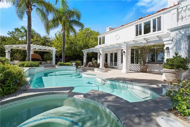 a view of a house with swimming pool and a garden