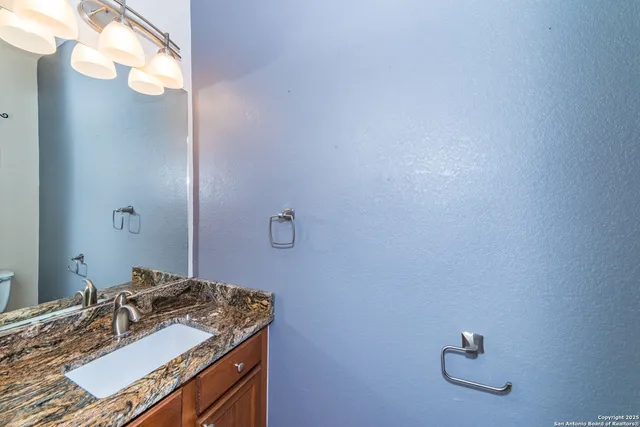 a bathroom with a sink vanity and a mirror