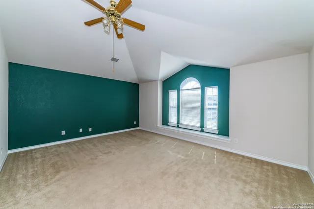 an empty room with windows and closet