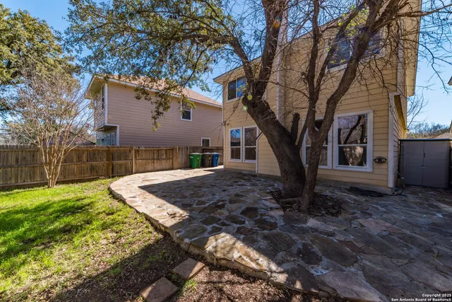 a view of a backyard with large trees