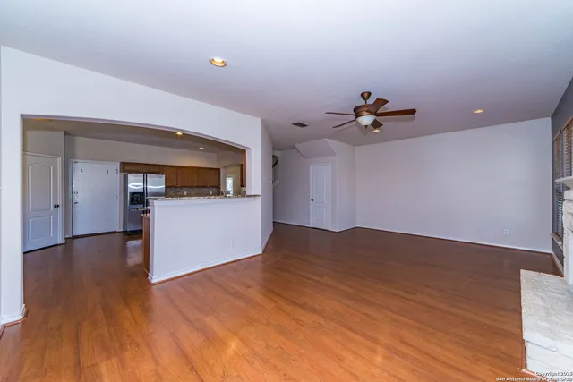 a view of a kitchen with wooden floor and a sink