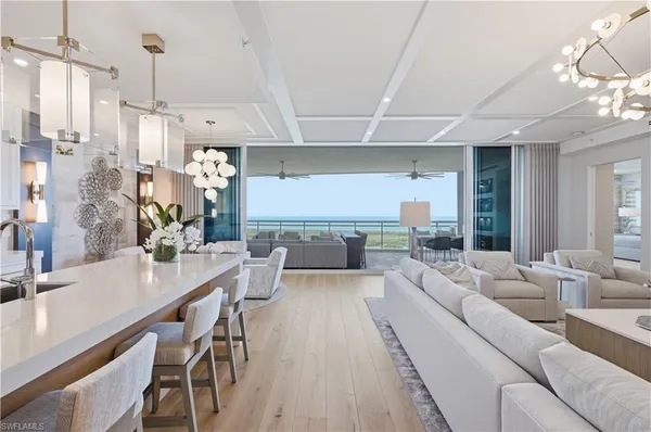 a living room with furniture and a chandelier