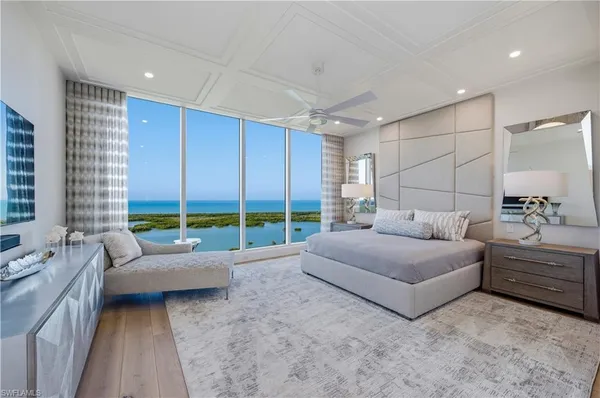 a living room with furniture and large windows