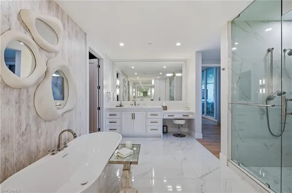 a bathroom with a granite countertop sink mirror vanity and toilet