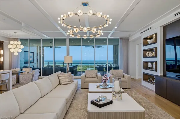 a living room with furniture and a chandelier