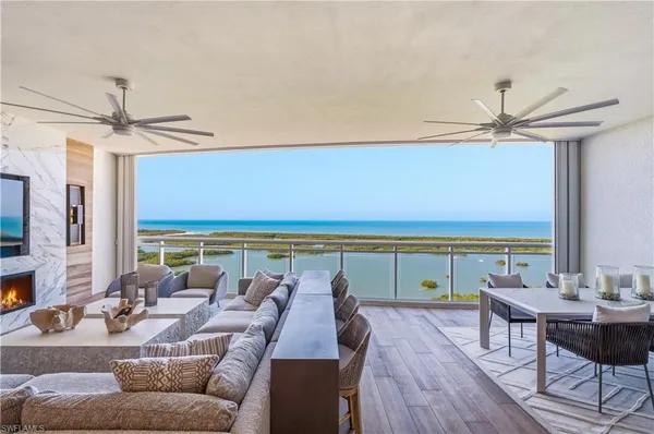 a living room with furniture a window and a flat screen tv
