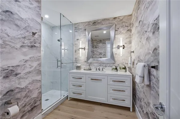 a bathroom with a double vanity sink mirror and shower