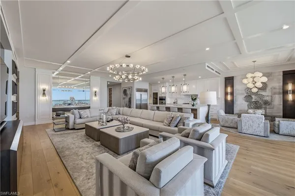 a living room with furniture and a chandelier