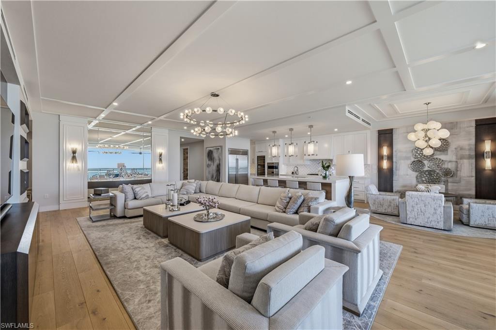 13945 Old Coast Road, Unit PH05 Naples, FL 34110 - Photo 3 of 37 a living room with furniture and a chandelier