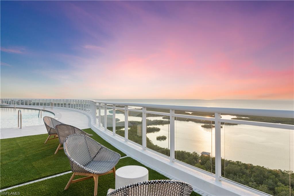 13945 Old Coast Road, Unit PH05 Naples, FL 34110 - Photo 32 of 37 a view of a chairs and table in the terrace
