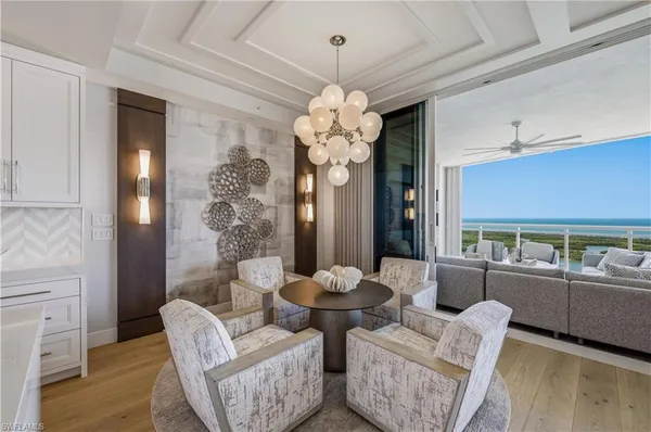 a living room with furniture and a chandelier
