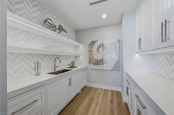 a kitchen with a sink and cabinets