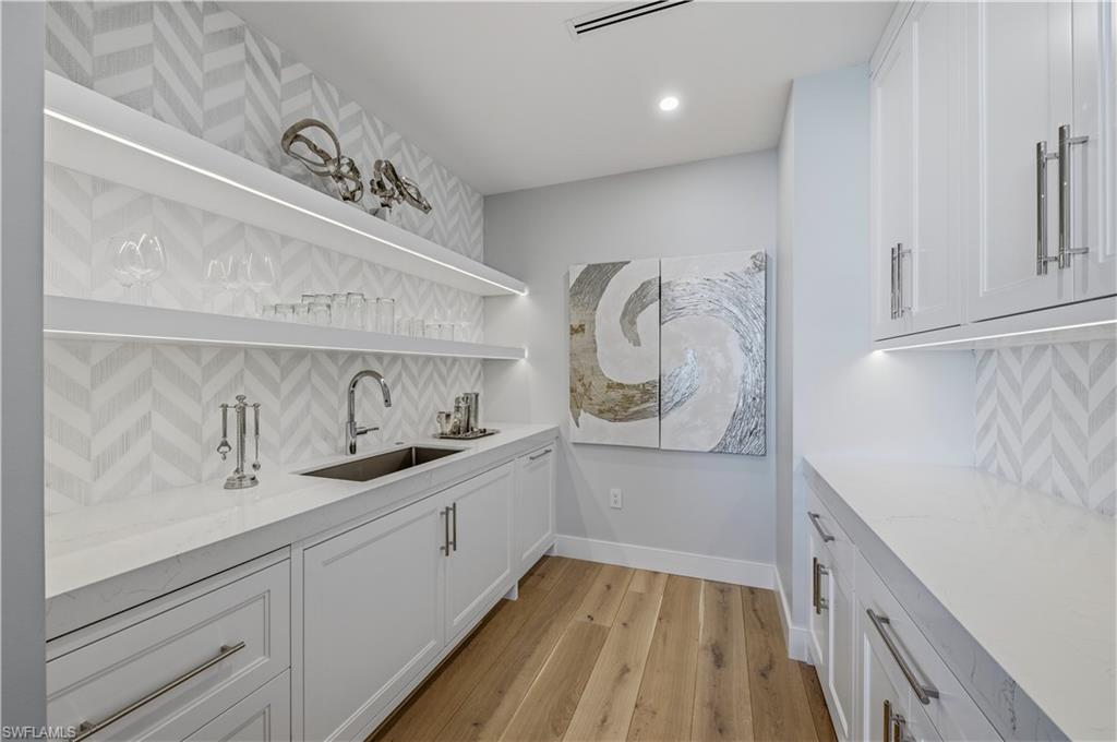 13945 Old Coast Road, Unit PH05 Naples, FL 34110 - Photo 10 of 37 a kitchen with a sink and cabinets