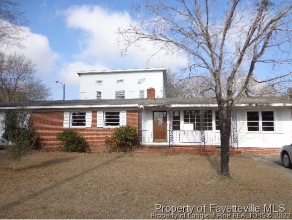 310 Turnpike Road Raeford, NC 28376 - Photo 1 of 6 a front view of a house with garden